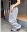 【continuer】キラキラロゴのスウェットパンツ