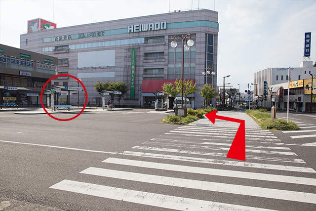 4.After exiting to the ground level, cross the crosswalk, aiming for the #2 Bus Stop. (Circled)
